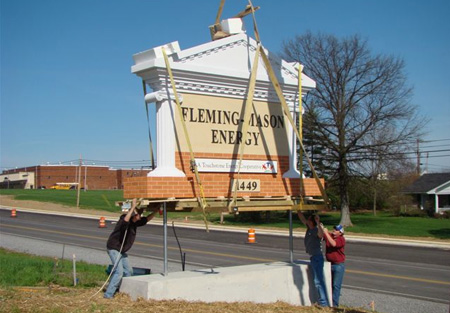Monument installation using crane on concrete base