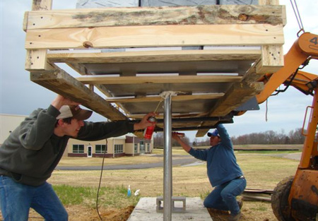 Monument installation using expanding adhesive as lowered